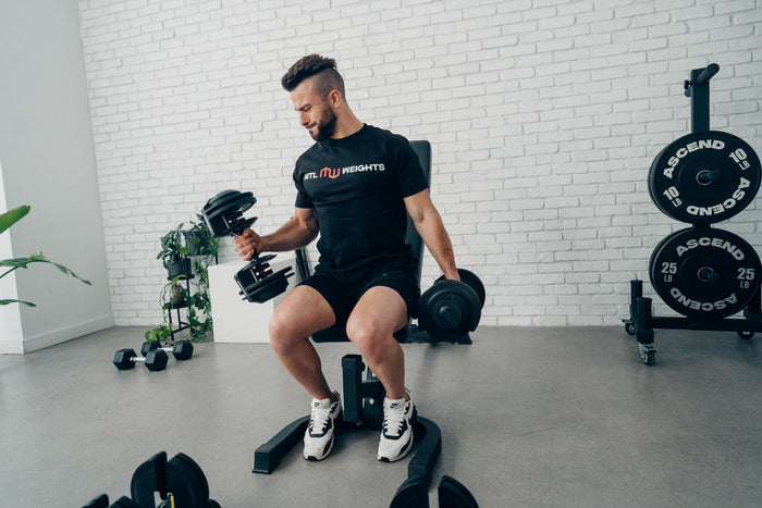 Man using adjustable dumbbells